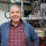 Mark Saffman poses in front of equipment in his lab