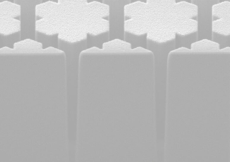 greyscale abstract image of things that appear to look like 3D towers in the shape of snowflakes
