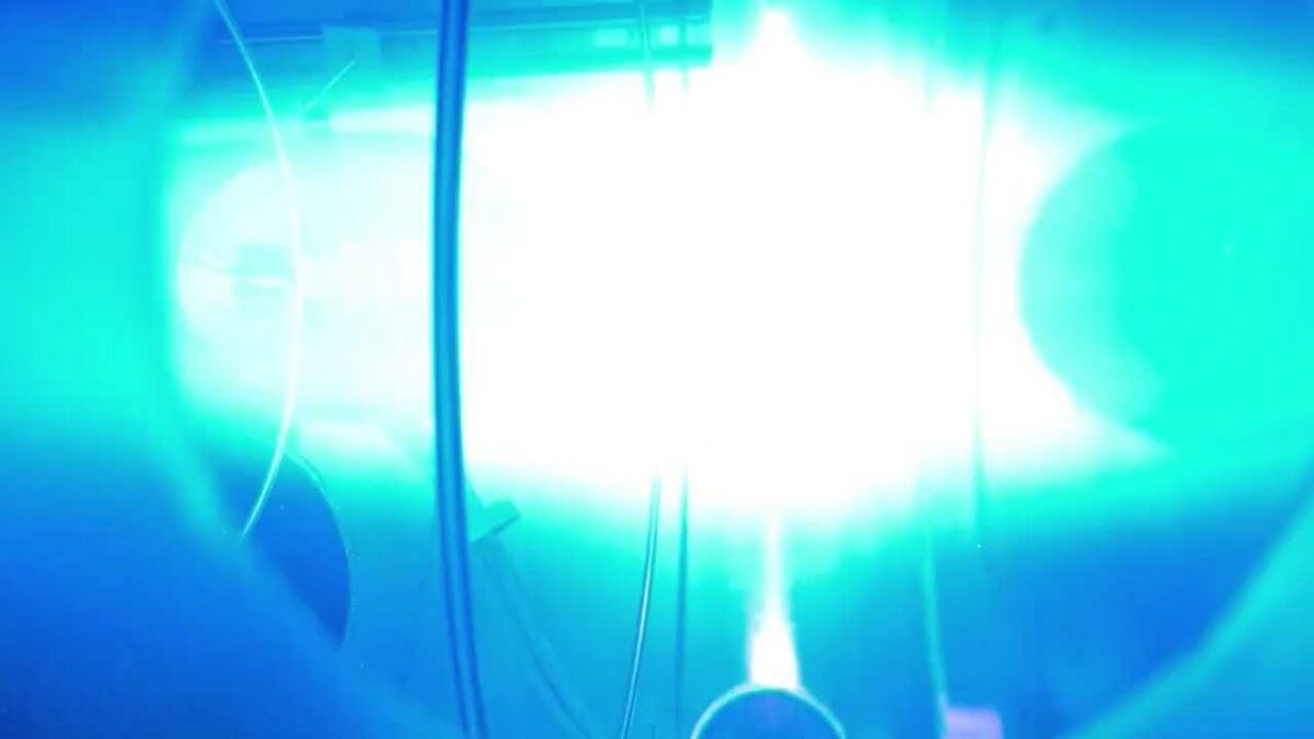 a cyan blue cloud of light illuminates the majority of the shot