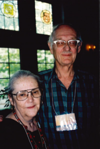 a man and woman stand next to each other